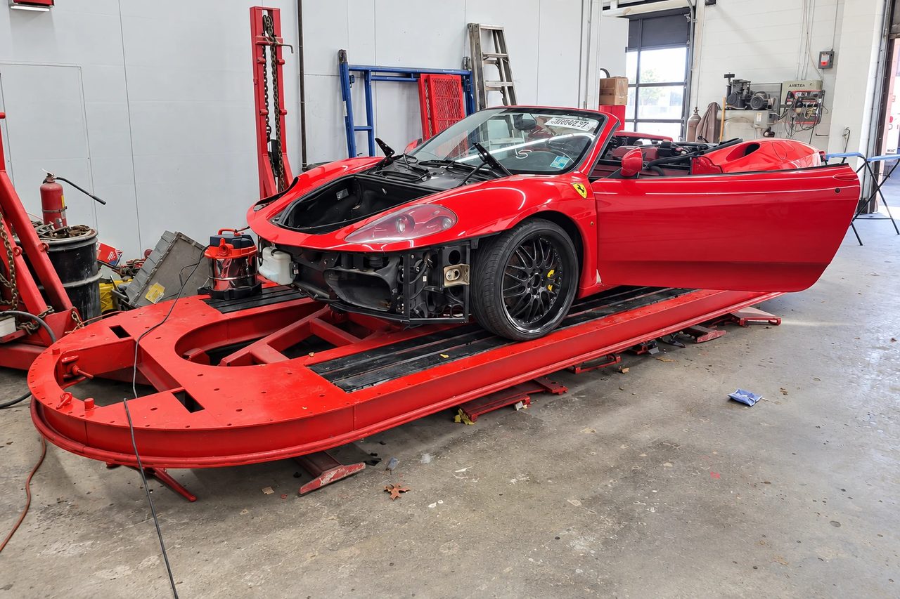 A red sports car in J & J’s repair workshop