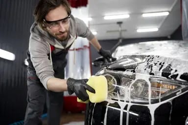 Hand washing the exterior of a car