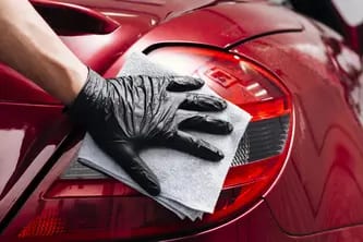 Wiping a vehicle’s exterior finish with a microfiber cloth
