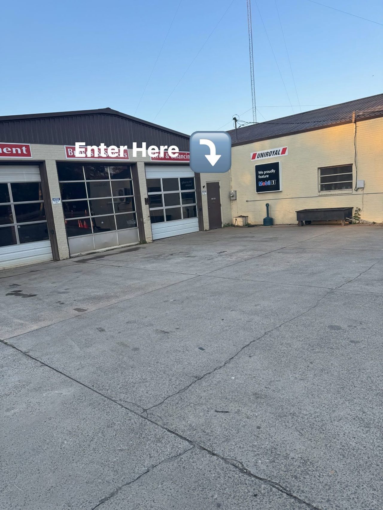 Shop-posted photo marking the entrance beside Jasper Tire's service bays
