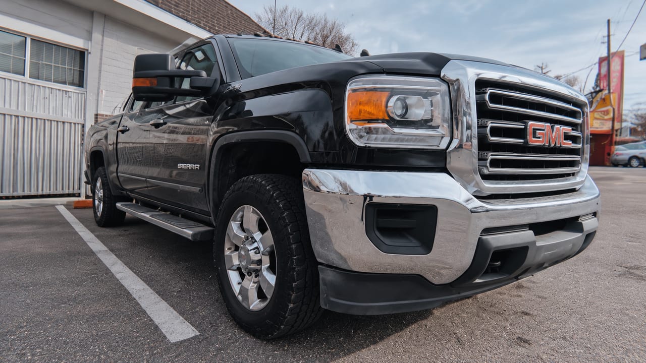 Black pickup outside the shop — AI-assisted adaptation of owner photo