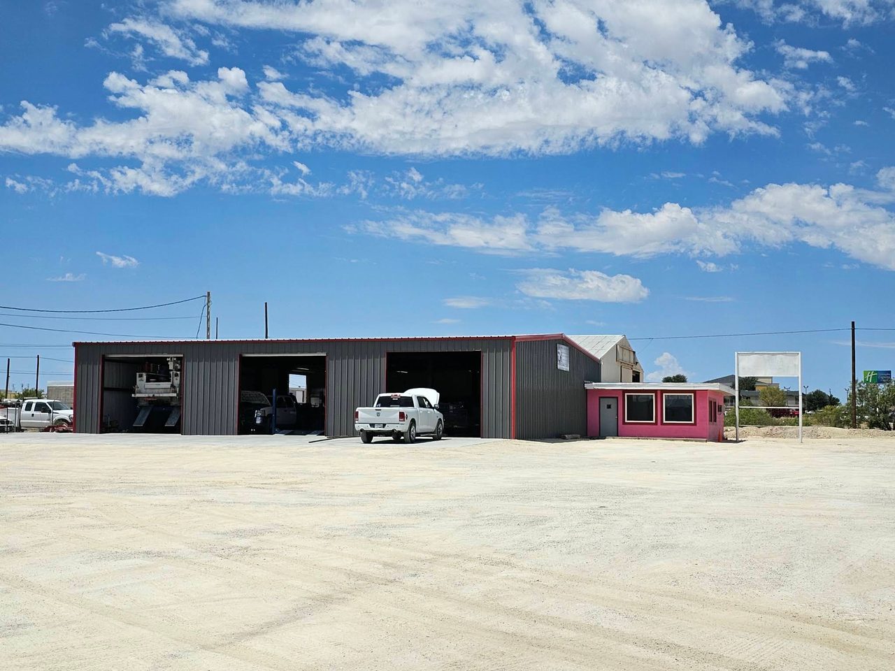 Alamo Tire & Auto Repair service bays and pink office on West Dickinson Boulevard