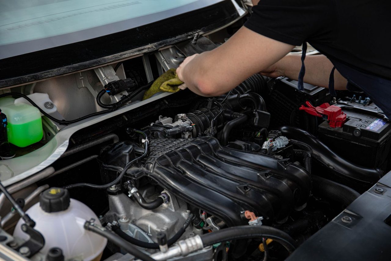 Mechanic working under the hood of a vehicle