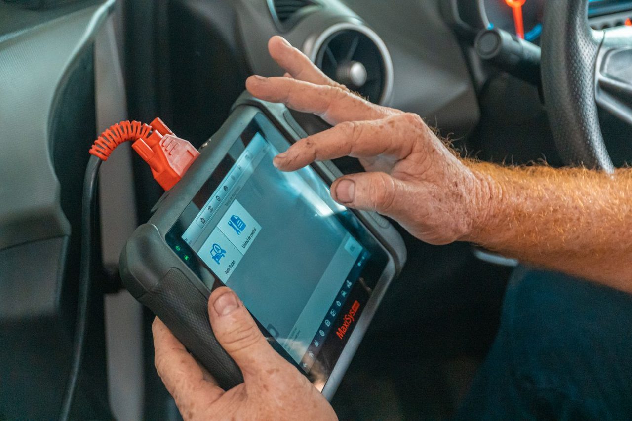Handheld diagnostic scanner inside a vehicle