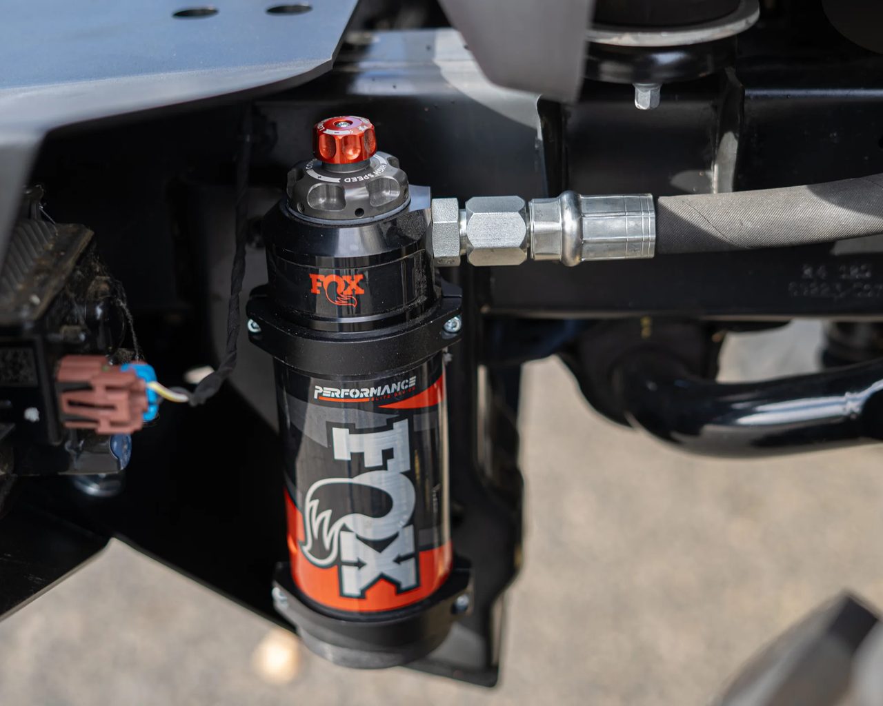 Close-up of a Fox shock reservoir on a Jeep