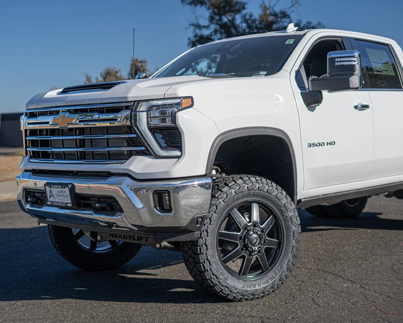 White Chevrolet pickup with upgraded wheels