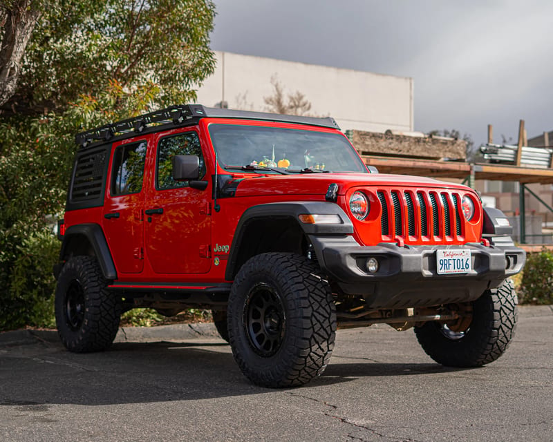 Red Jeep Wrangler outside the shop