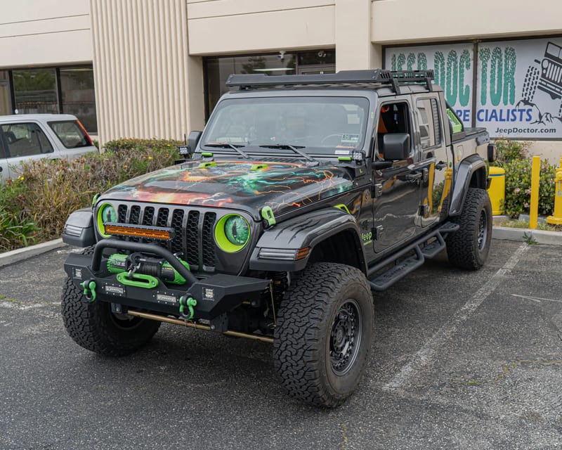 Jeep Gladiator with green accents and custom graphics
